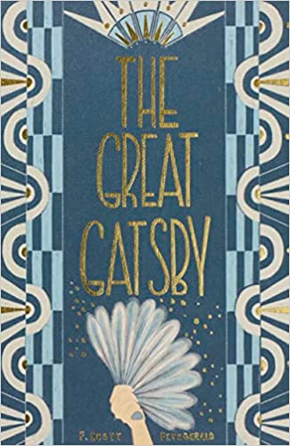 blue cover of great gatsby with art deco print and illustration of hand holding a feather fan