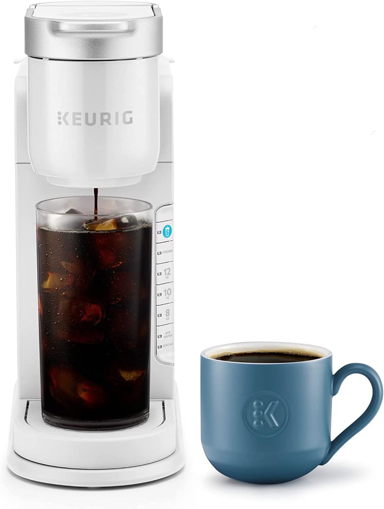 white keurig machine with iced coffee and mug